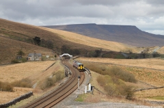 Photograph: Train with Grisedale footbridge and Wild Boar Fell beyond.
